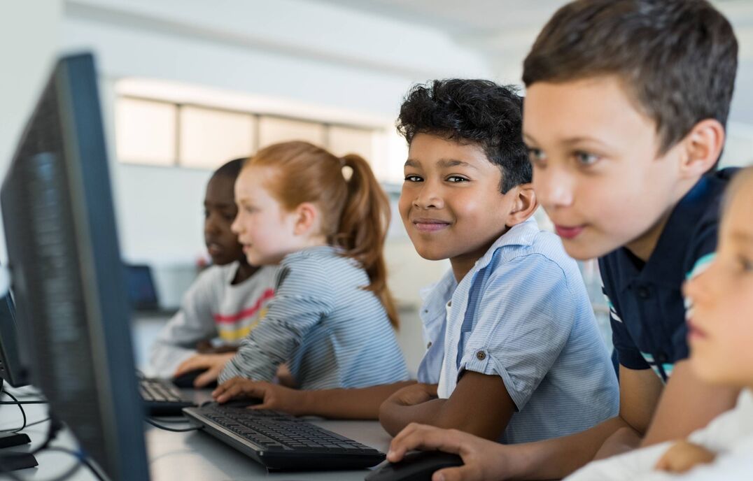 boy in classroom in front of computer